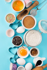 Obraz na płótnie Canvas Ingredients and utensils for baking, blue background