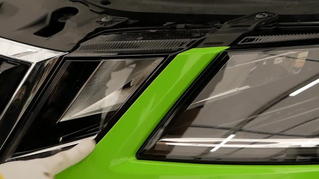 Car wrapping specialist putting vinyl foil or film on car.