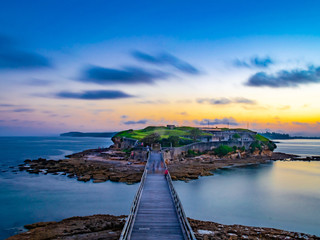 Fototapeta na wymiar Sunset over an island with a bridge