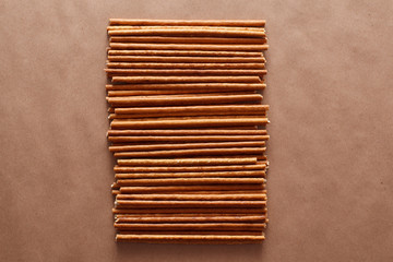 Crispy bread straw on brown paper background