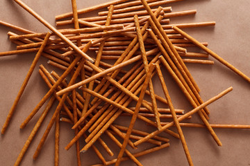 Crispy bread straw on brown paper background