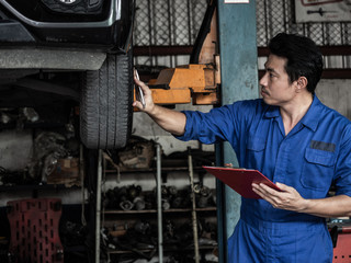 Fototapeta na wymiar garage worker concept.Smiling happy mechanic technician worker at car repair service station