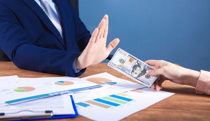 businessman in the office refuses to take a bribe
