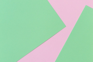 Pastel color paper background. Pink and green color layout composition