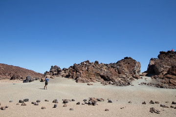 Fototapeta na wymiar mountain desert with volcanic rocks, panorama of a rocky desert with red earth and sand