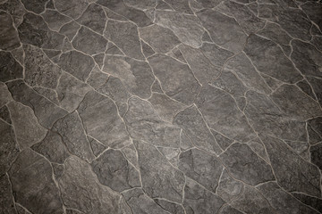 A tile of grey stone background