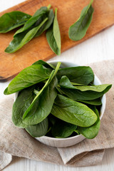 Raw spinach in a bowl, low angle view. Close up.