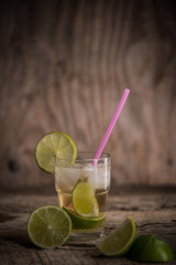 Coctail drink Caipirinhaof Brazil with lemon and lime on wooden table