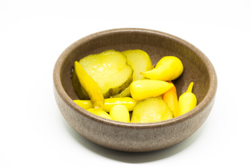 Pickled rosemary and sliced ​​cucumbers in brown bowl
