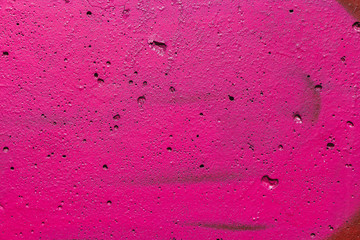 Beautiful horizontal texture of part of old concrete wall painted in pink color with holes on the photo