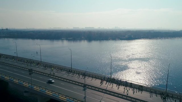 Marathon running on the bridge. Dolly shot