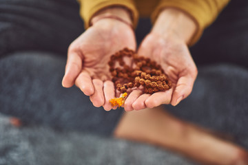 Close up of woman holding Tibetan prayer beads.