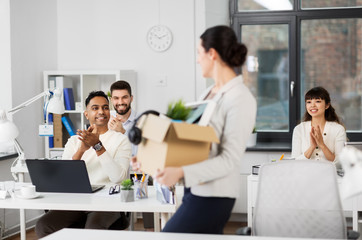 business, job and quit concept - happy smiling colleagues applauding to female office worker