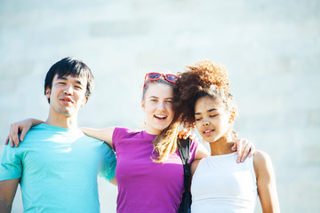 cute group of teenages at the building of university with books huggings, diversity nations students lifestyle