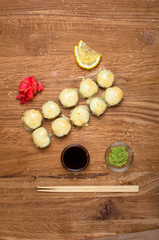 Unusual sushi rolls on a wooden table. Ukrainian sushi rolls with baked cheese and crabs