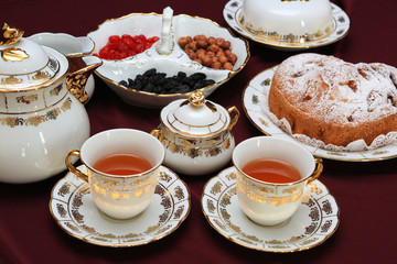cup of tea and cakes on plate
