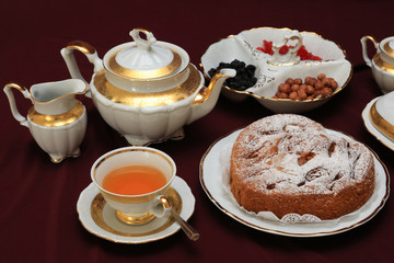 cup of tea and cakes on wooden table