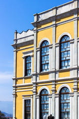 Vertical shoot of old turkish yellow colored masonry classic building with blue background in Safranbolu