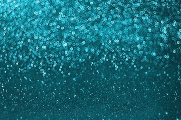 Blue glitter lights background. Defocused. Blue Festive Christmas elegant abstract background with bokeh lights. Beautiful blue bokeh. Place for text. copy space for text. Holiday concept,new year.