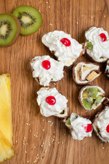 Sweet rolls made of pancakes filled with fruit and covered with cream and jam. Sweet breakfast Delicious dessert