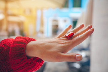Female hand with a red ring © AboutLife