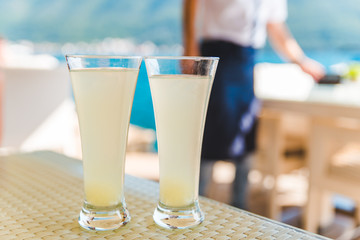 two glasses of juice on cafe table