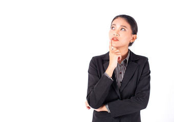 Portrait isolated Southeast Asian business woman wears dark gray suit is looking at left top side and place her hand on chin with white background