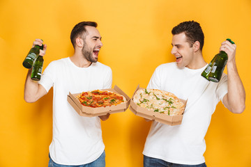 Image of two content men bachelors 30s in white t-shirts holding pizza boxes and beer bottles