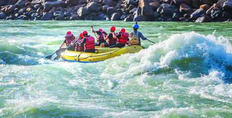 White water river rafting in Rishikesh, India. Sports activity by group of tourist. - obrazy, fototapety, plakaty
