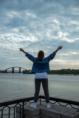 woman looking on sunrise over the river.