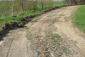 Dirt road leveled by a grader. Road in village
