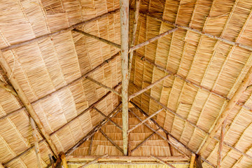 Bamboo roof frame. Wooden roof under construction. Bamboo ceiling.