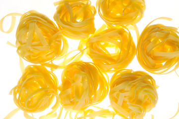 Yellow pasta on a white background. Close-up