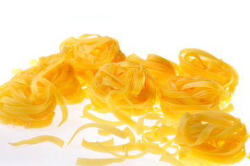 Yellow pasta on a white background. Close-up