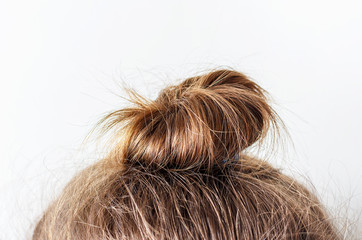 Modern hairstyle bun on white background, copy space