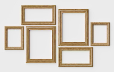 Wooden picture or photo frames on white wall with shadows