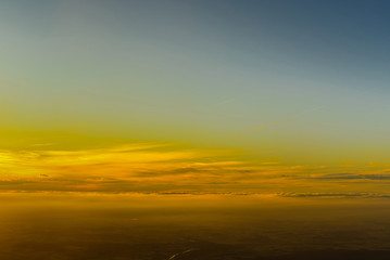 Fototapeta na wymiar landscape sunrise or sunset from the window of the plane