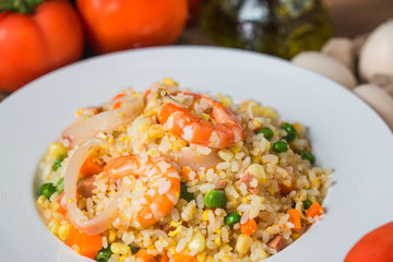 Seafood fried rice on wooden background，Thai Food ，Shrimp fried rice.