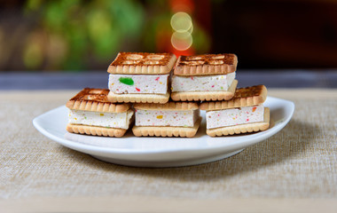 Cookies with marshmallows and marmalade on a white plate. Fresh homemade pastries.