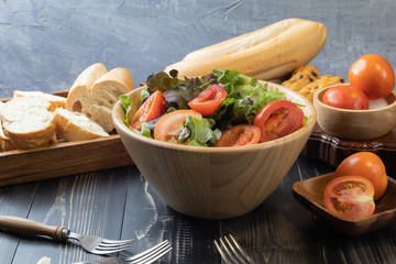 tomato and green oak lettuce salad on bowl