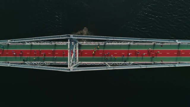 Marathon running on the footbridge. Top view shot