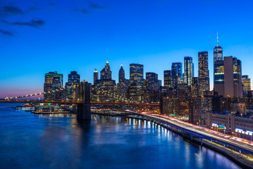 Fototapeta na wymiar Brooklyn Bridge in Manhattan downtown with Cityscape at sunset New York USA