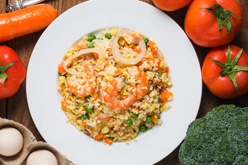 Seafood fried rice on wooden background，Thai Food ，Shrimp fried rice.