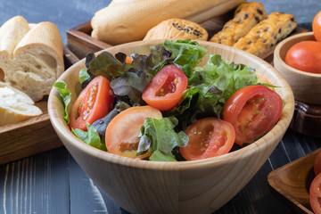 tomato and green oak lettuce salad on bowl