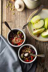 Healthy breakfast.Two bowls of muesli with oats, nuts and dried fruits - apples, resins, pumpkin seeds and almonds on wooden table. Top view. Rustic style.