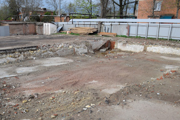 ruined foundation of an old building, the walls of the basement of a demolished building and debris.