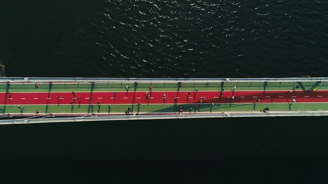 Marathon running on the footbridge. Top view shot