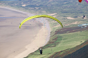 Paraglider flying at Rhossili, Wales