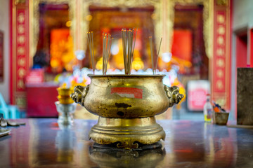 burning many incense in a golden pot