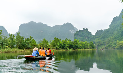 Fototapeta na wymiar Touristic rowboat at the Trang An Landscape Complex in Vietnam